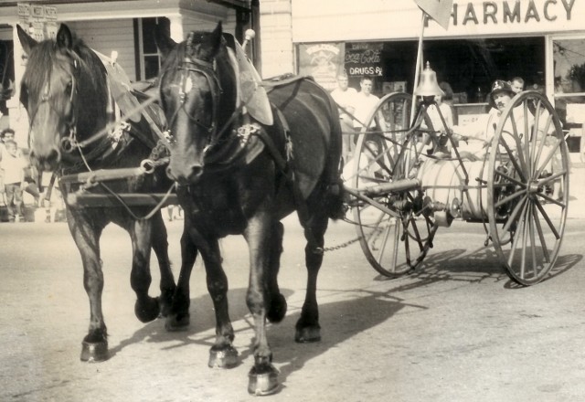 One on the original 1893 Hose Carts being pulled through the 1961 parade